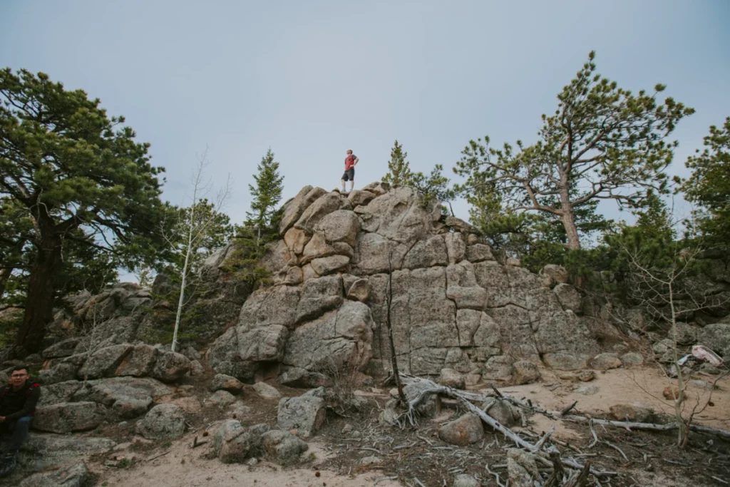 Person meditating on top of a boulder, symbolizing mental well-being and management for mood disorders through nutrition 