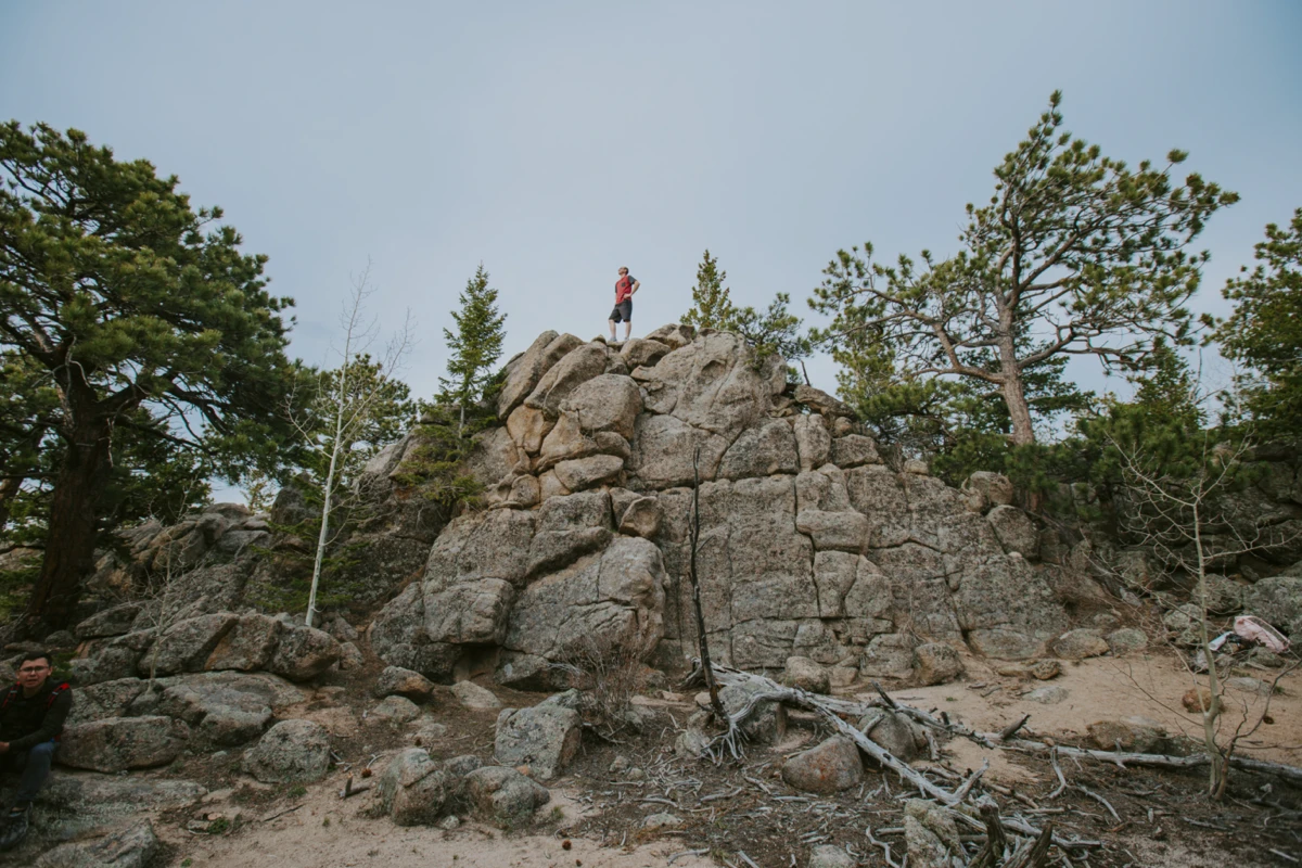 Person meditating on top of a boulder, symbolizing mental well-being and management for mood disorders through nutrition
