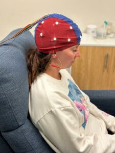 A woman receiving neurofeedback therapy as part of alternative treatments for behavioral challenges