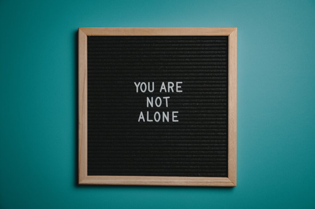 OCD treatment options symbolized by a board with the message 'You Are Not Alone,' highlighting support through neurofeedback, nutrition, and IV therapies.