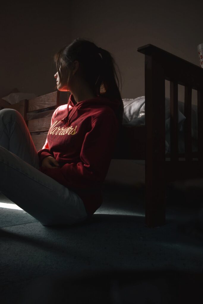 A tired woman in her bedroom, representing the challenges of finding effective adult sleep disorder treatment.